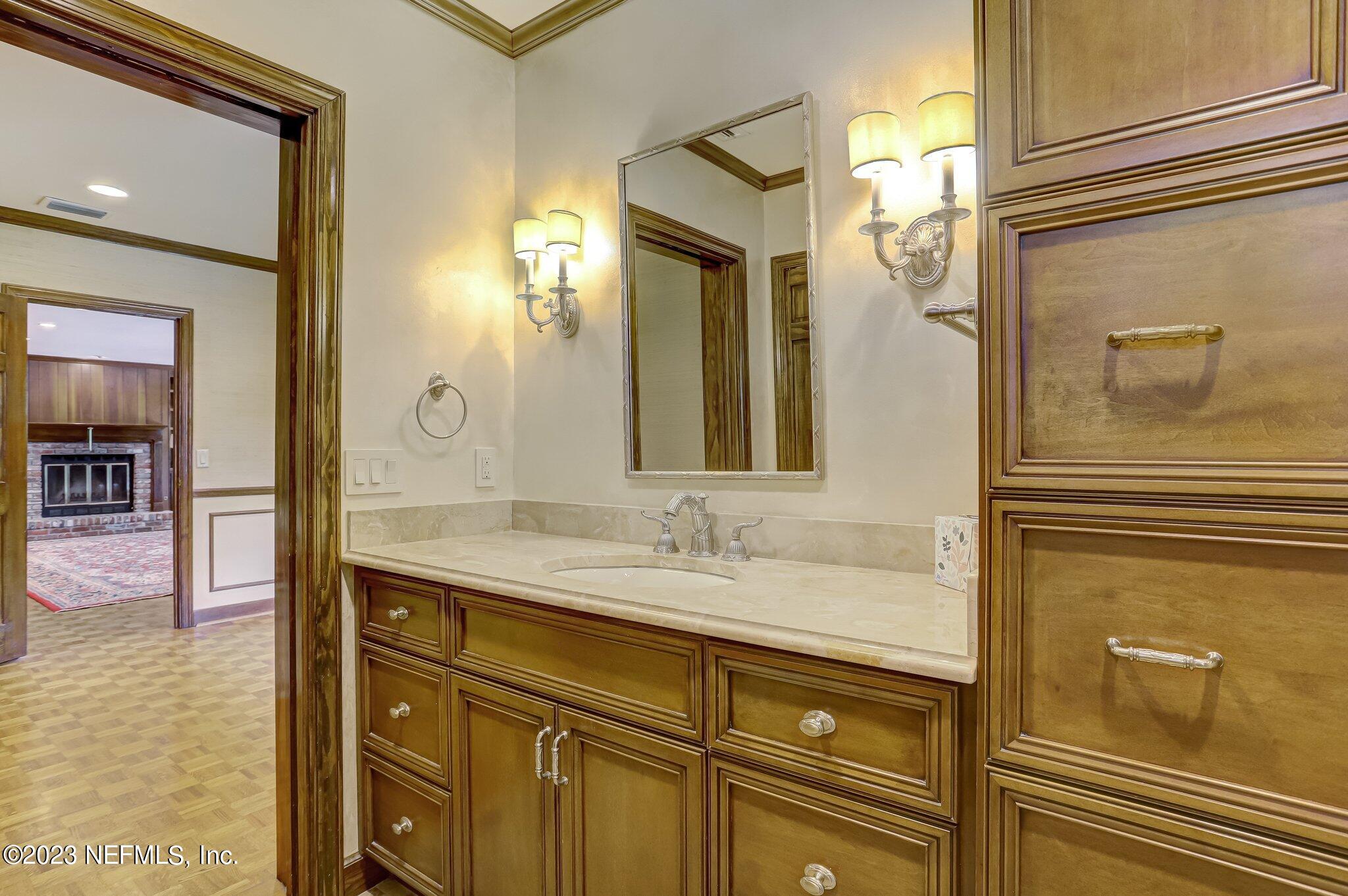 4143 Sherwood Road Jacksonville, FL 32210 - Photo 39 of 67 a bathroom with a sink a mirror and a shower