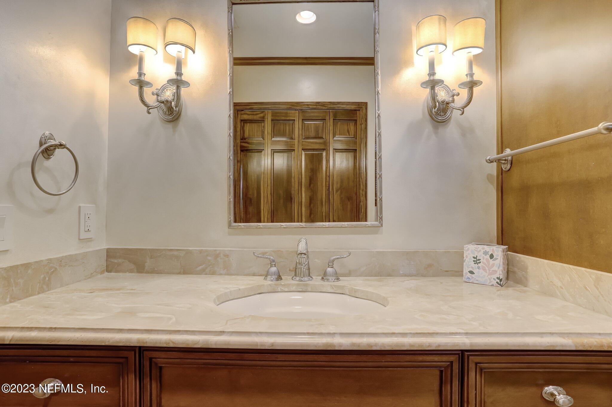 4143 Sherwood Road Jacksonville, FL 32210 - Photo 40 of 67 a bathroom with a sink and mirror
