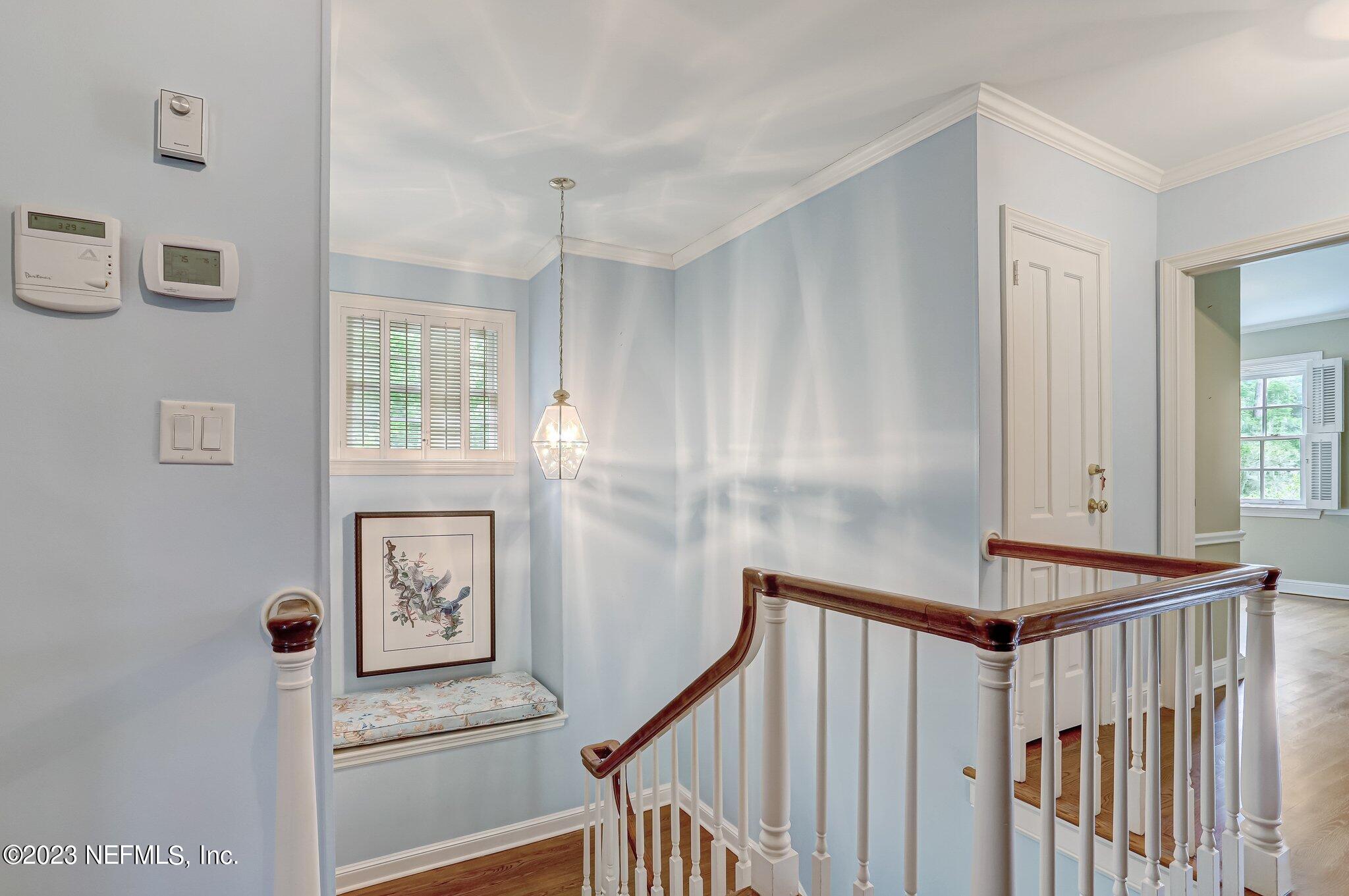 4143 Sherwood Road Jacksonville, FL 32210 - Photo 42 of 67 a view of a hallway with paintings on the wall