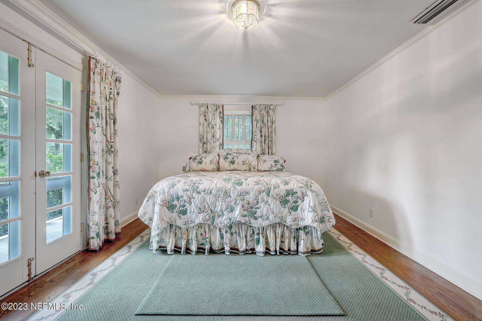 4143 Sherwood Road Jacksonville, FL 32210 - Photo 43 of 67 a bed sitting in a bedroom next to a window