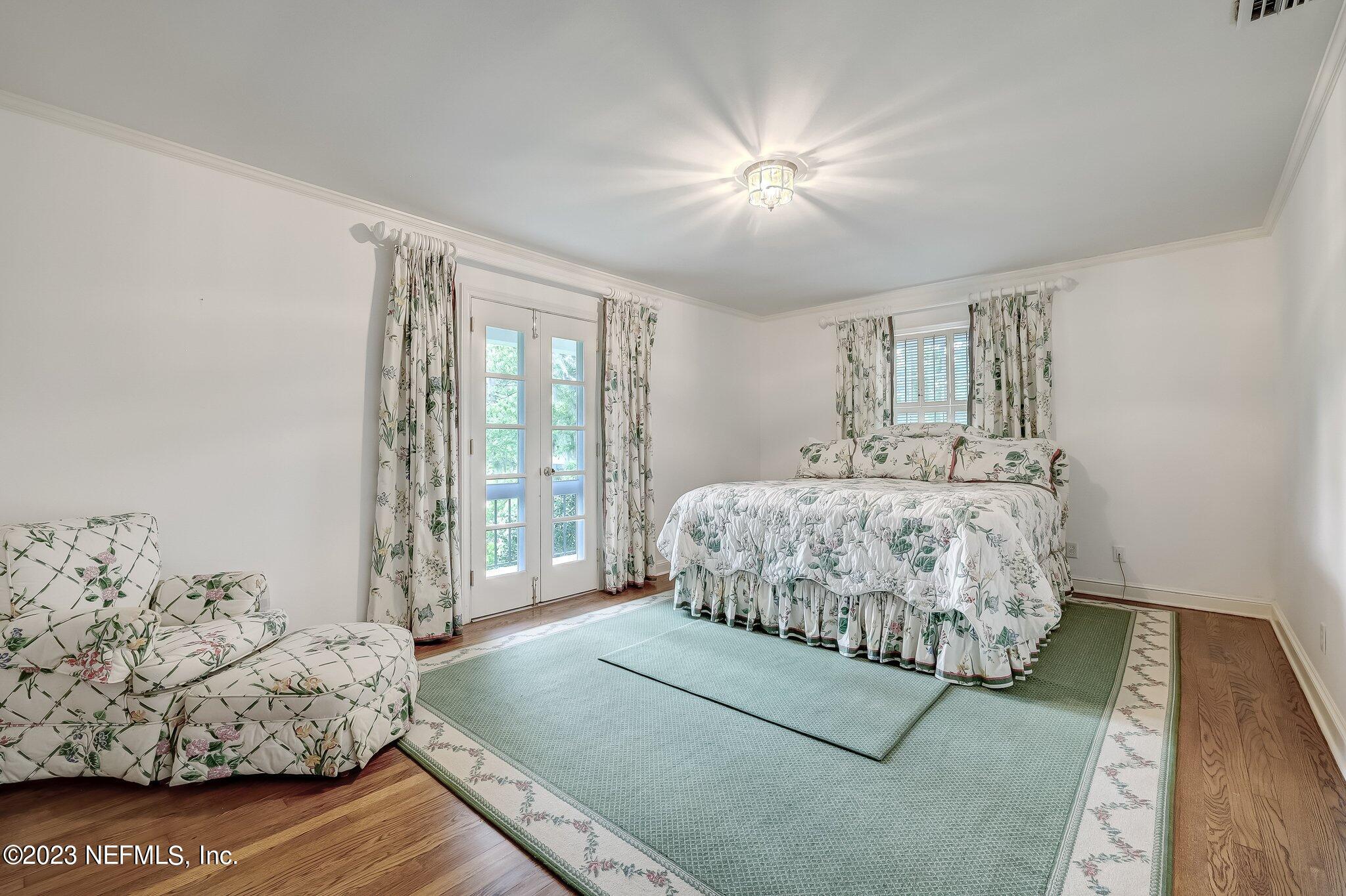 4143 Sherwood Road Jacksonville, FL 32210 - Photo 44 of 67 a bedroom with a large bed and a window