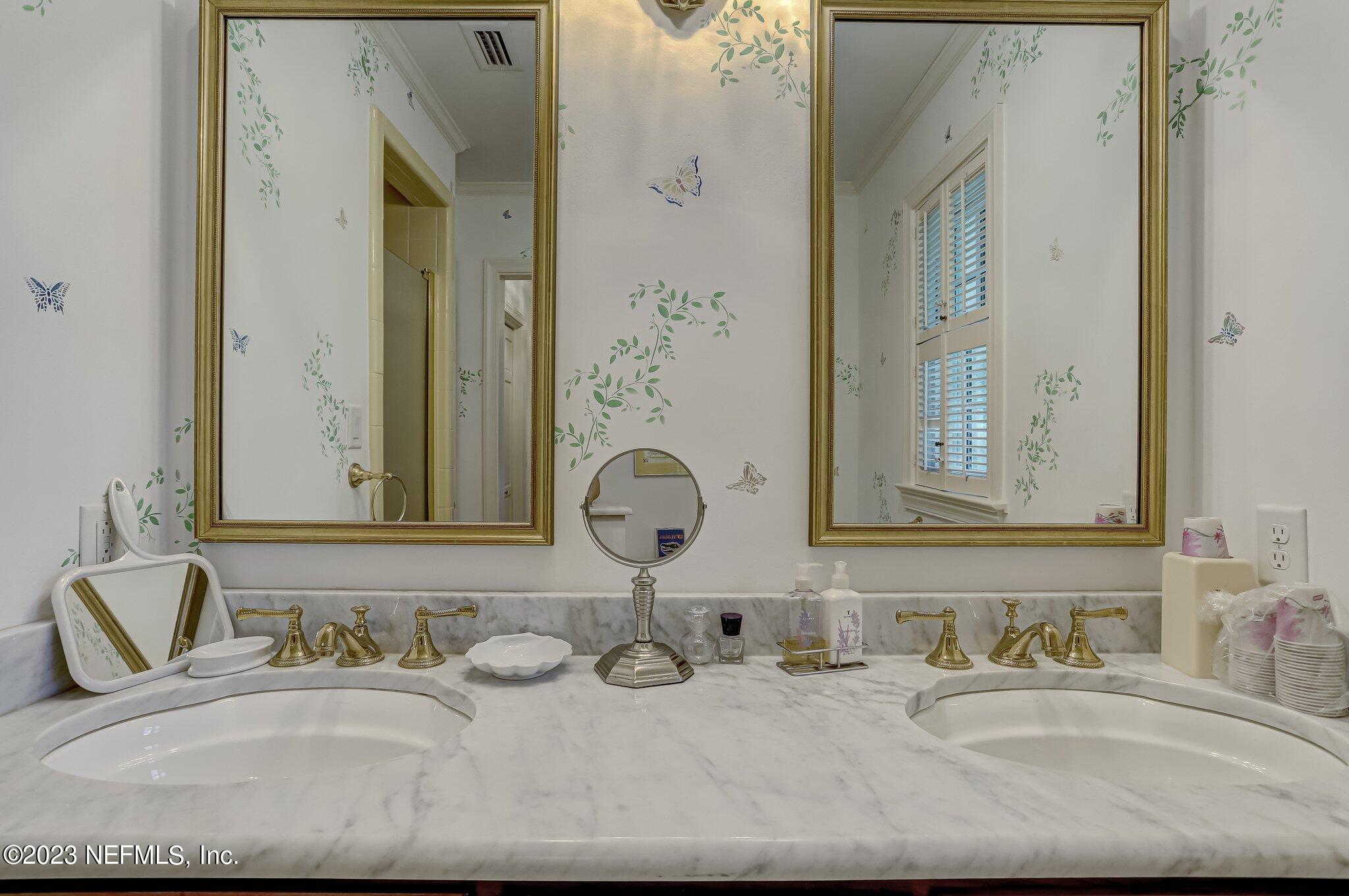 4143 Sherwood Road Jacksonville, FL 32210 - Photo 47 of 67 a bathroom with sinks and a mirror