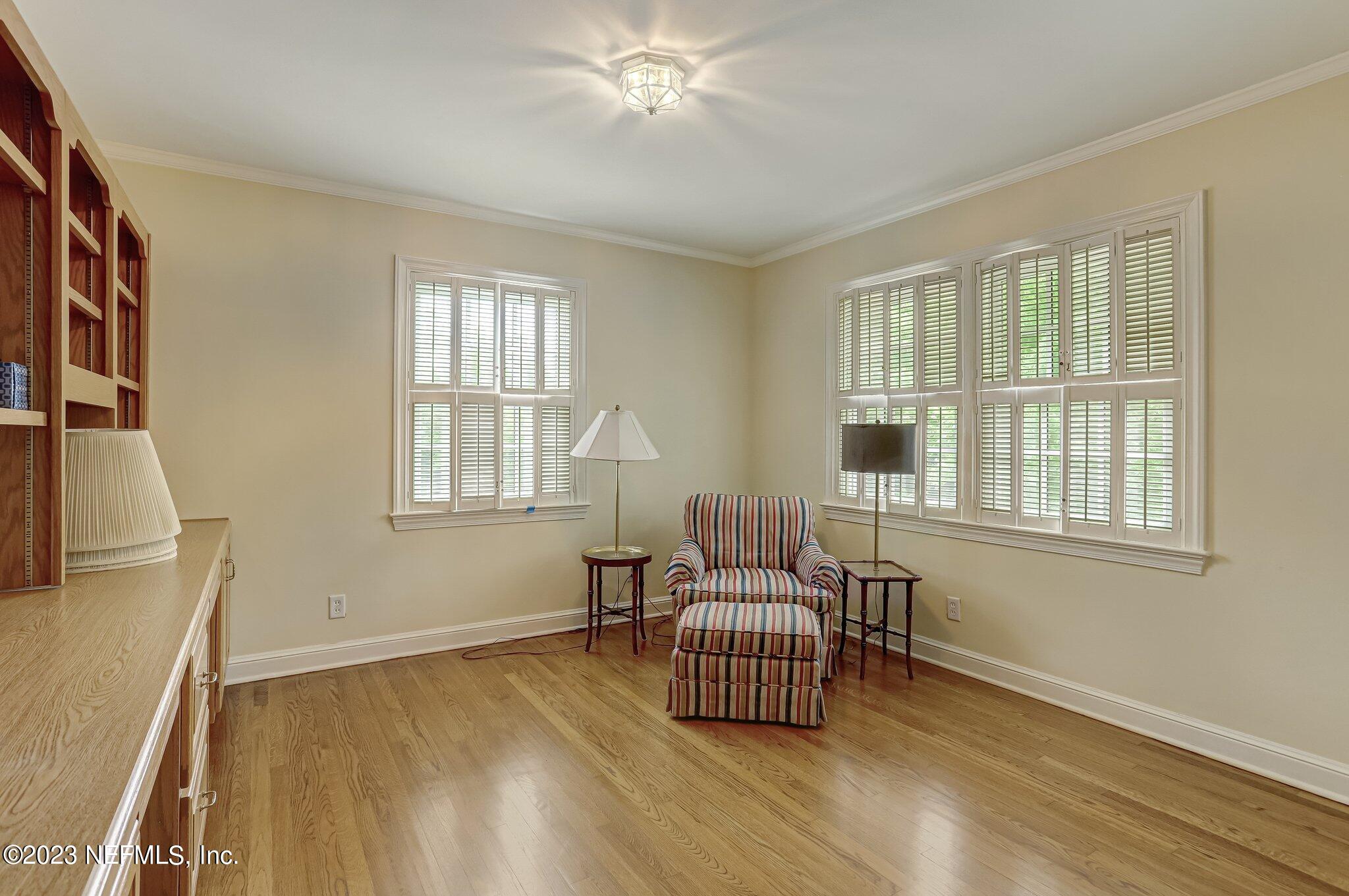 4143 Sherwood Road Jacksonville, FL 32210 - Photo 48 of 67 a bedroom with a bed and wooden floor