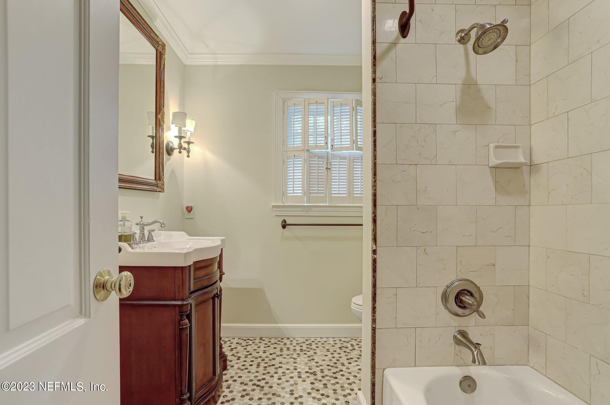 4143 Sherwood Road Jacksonville, FL 32210 - Photo 50 of 67 a bathroom with a sink a toilet and shower