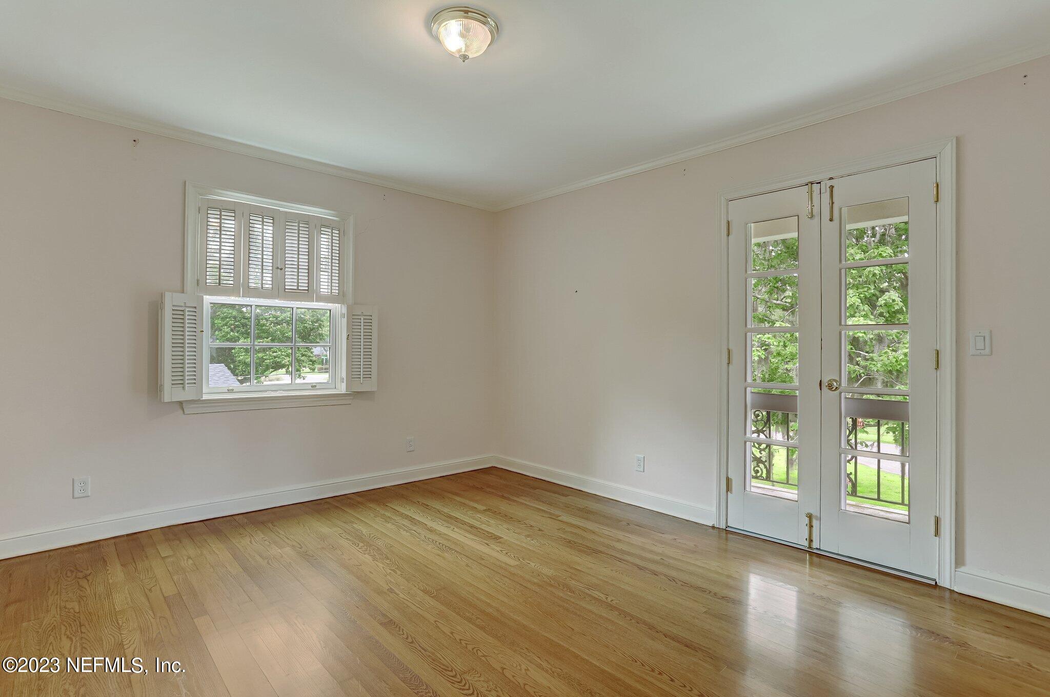 4143 Sherwood Road Jacksonville, FL 32210 - Photo 52 of 67 a view of an empty room with wooden floor and a window