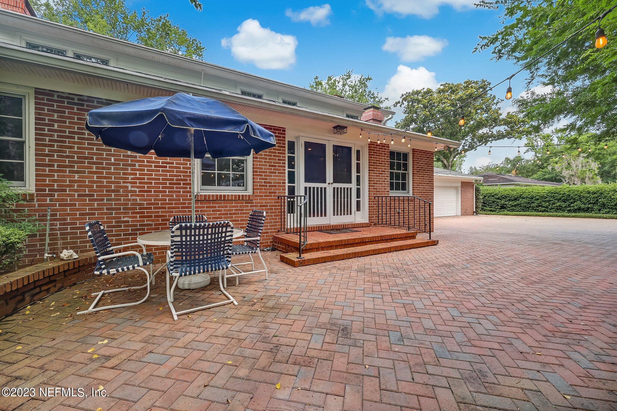 4143 Sherwood Road Jacksonville, FL 32210 - Photo 62 of 67 a backyard of a house with table and chairs