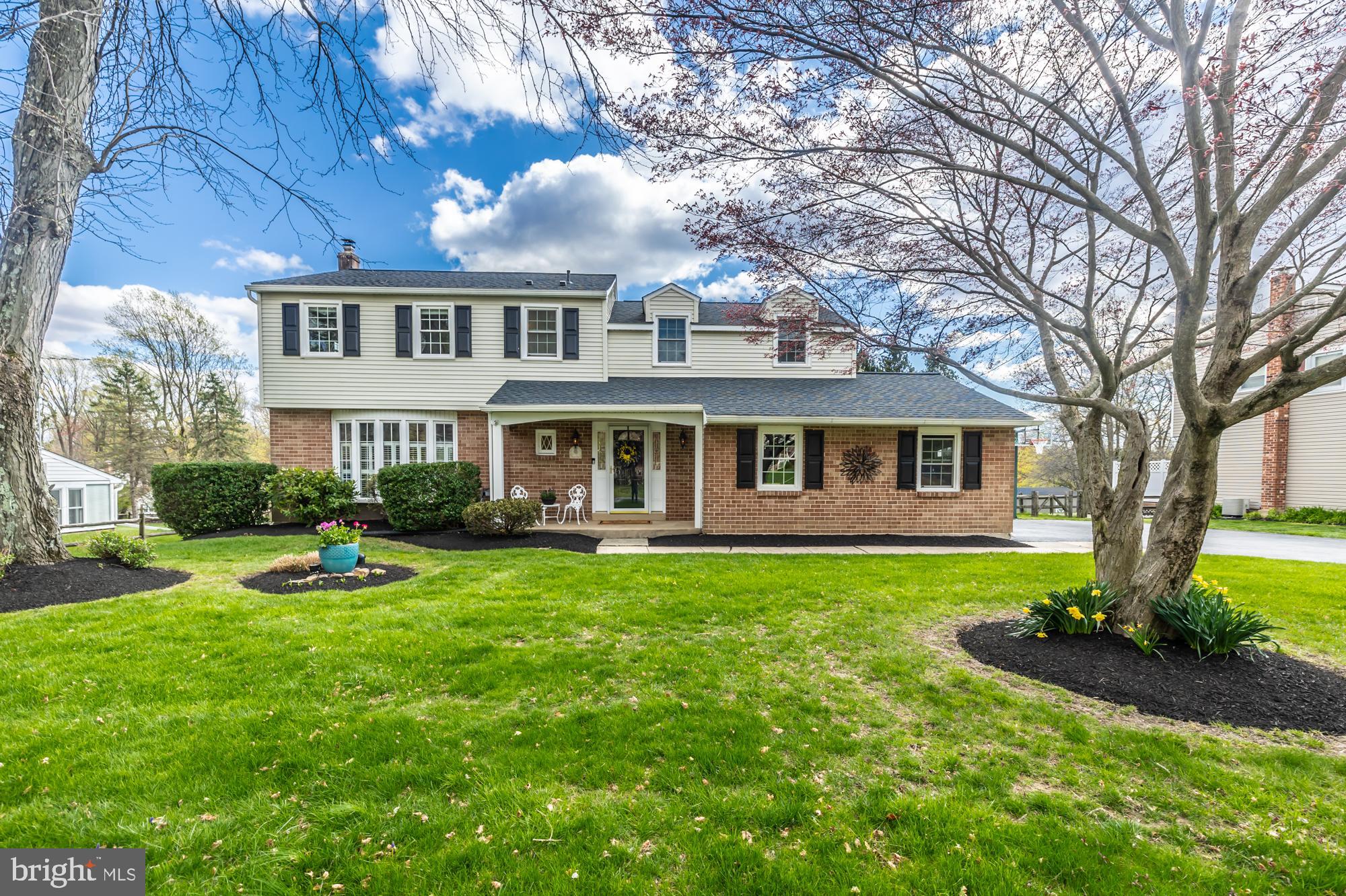 374 Devon Drive Exton, PA 19341 - Photo 2 of 50 a front view of a house with garden and trees