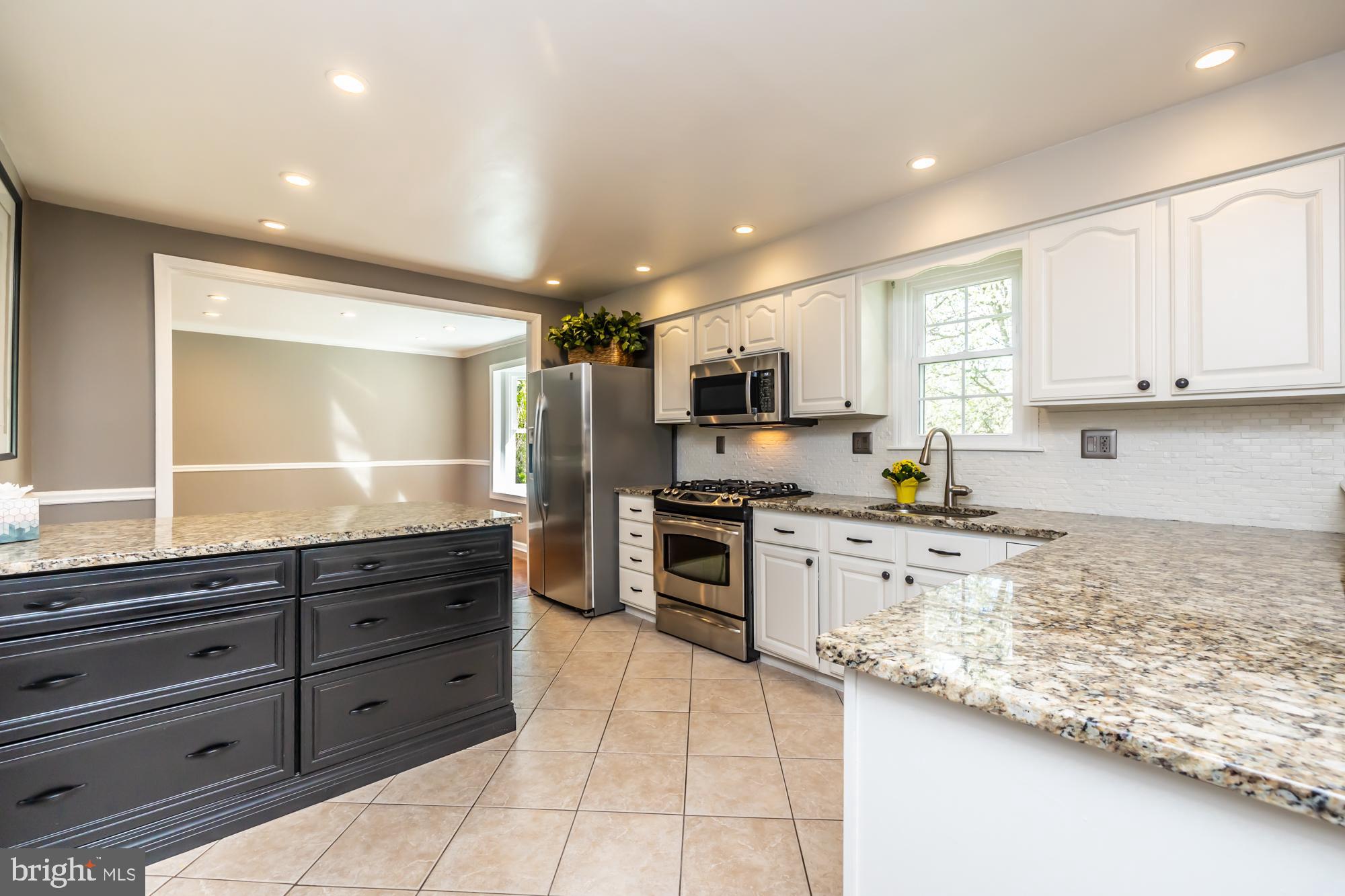 374 Devon Drive Exton, PA 19341 - Photo 25 of 50 a kitchen with stainless steel appliances granite countertop a stove sink and cabinets