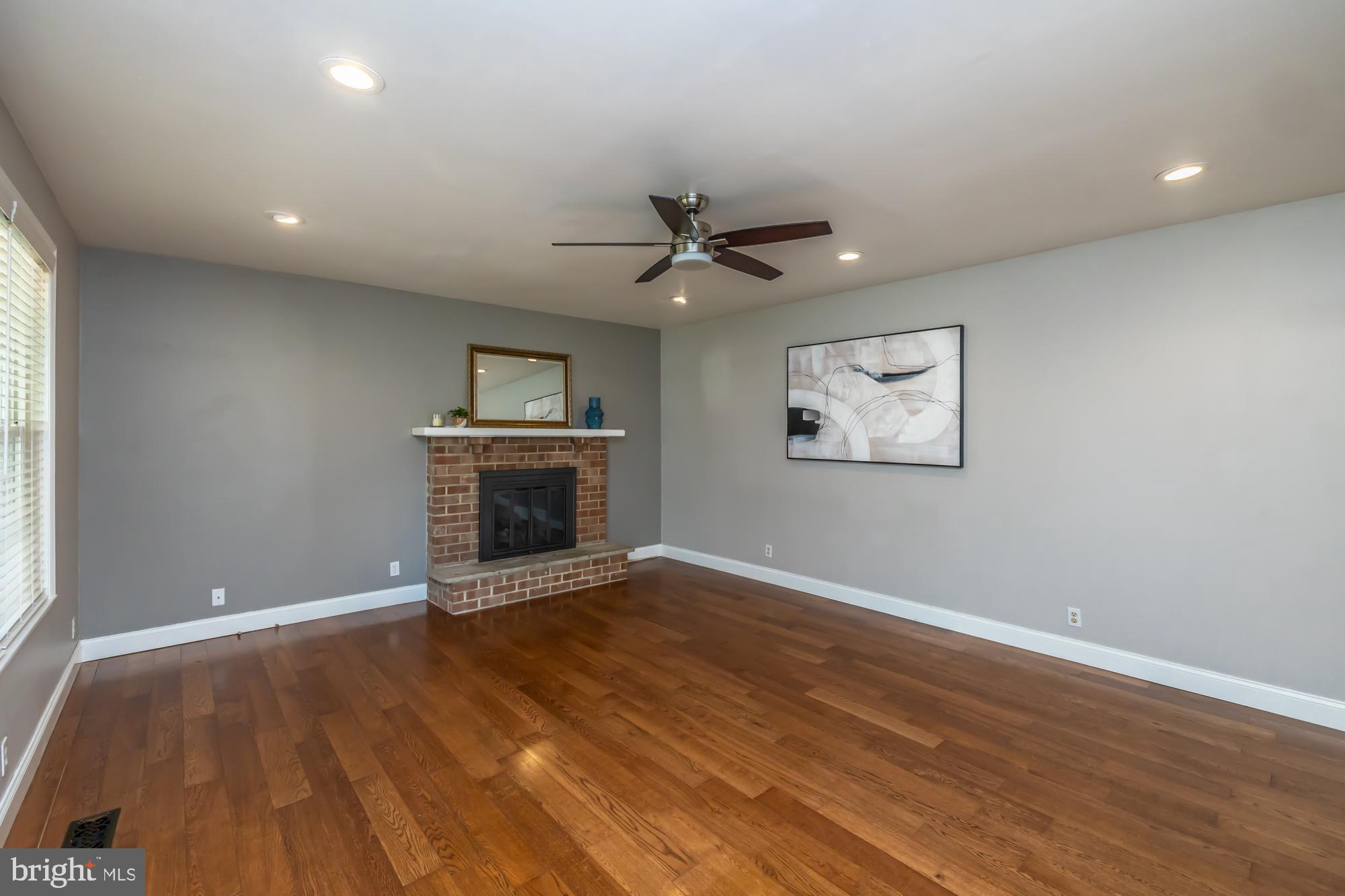 374 Devon Drive Exton, PA 19341 - Photo 30 of 50 an empty room with windows and a fireplace