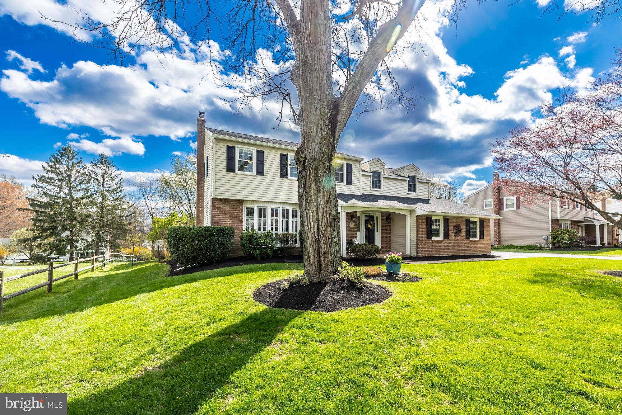 374 Devon Drive Exton, PA 19341 - Photo 3 of 50 a front view of a house with a yard table and chairs