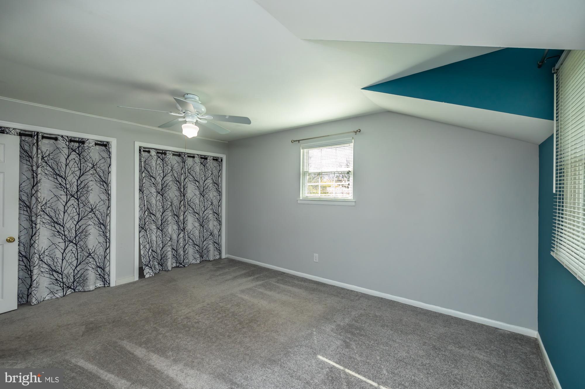 374 Devon Drive Exton, PA 19341 - Photo 45 of 50 a view of an empty room with window and chandelier fan