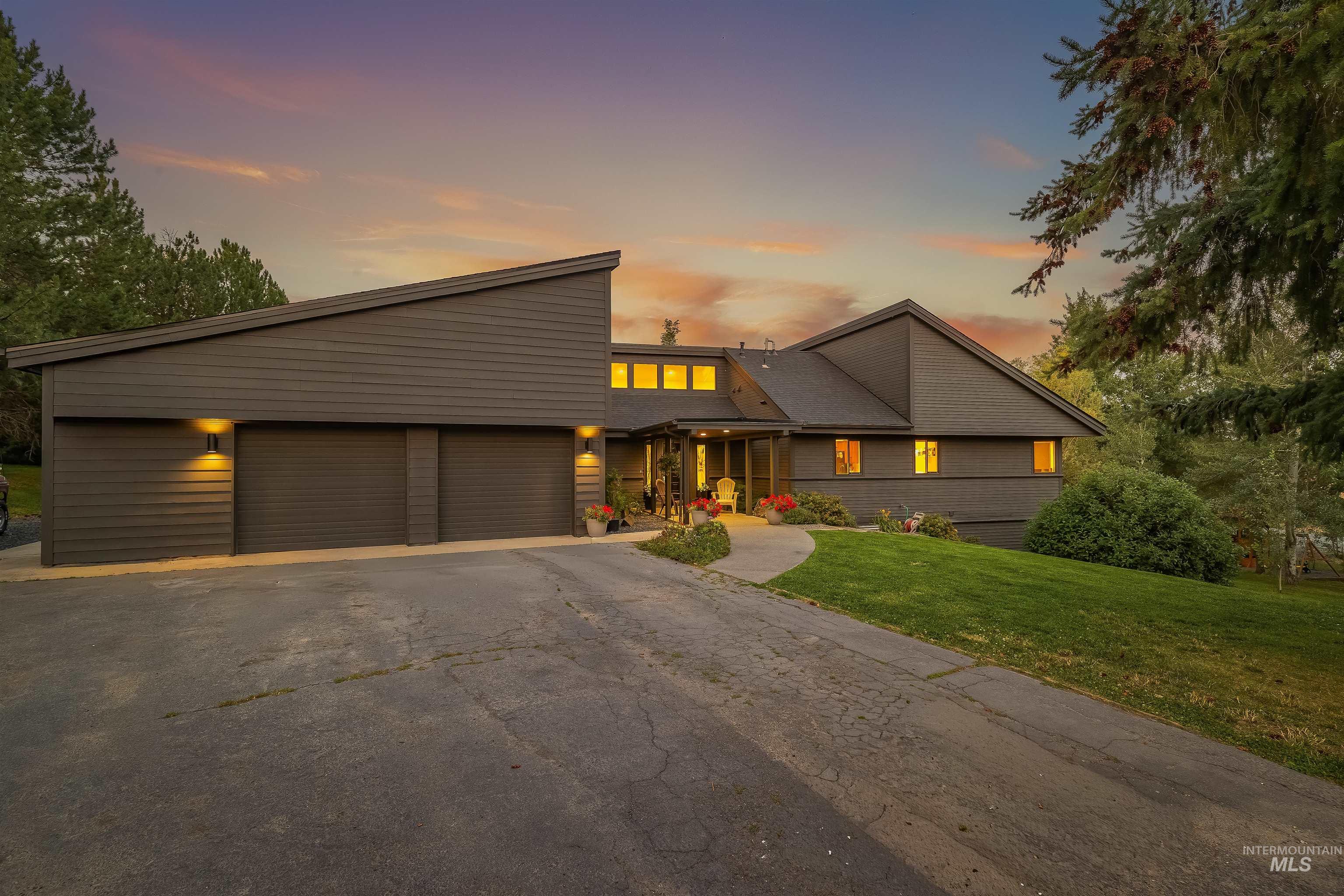 2048 Arborcrest Road Moscow, ID 83843 - Photo 42 of 50 Modern architectural design featuring horizontal siding, a two-car garage, and a sloped roofline