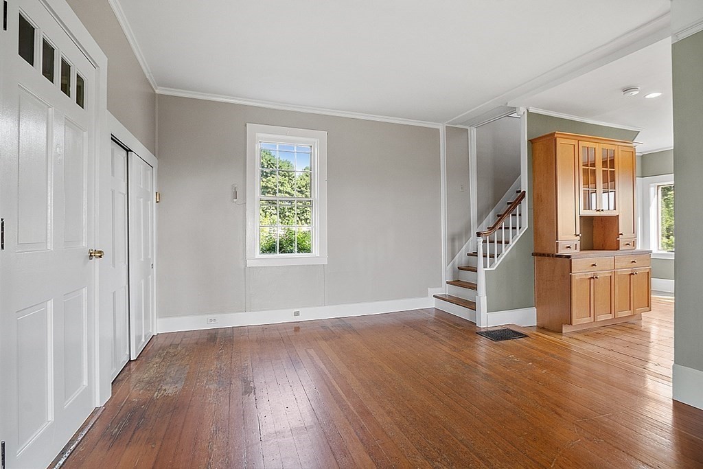 27 Worcester Road Princeton, MA 01541 - Photo 8 of 41 an empty room with wooden floor staircase and windows