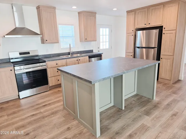 a spacious bedroom with a bed and a flat screen tv