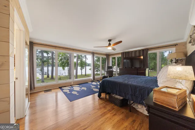 a bedroom with a bed and wooden floor