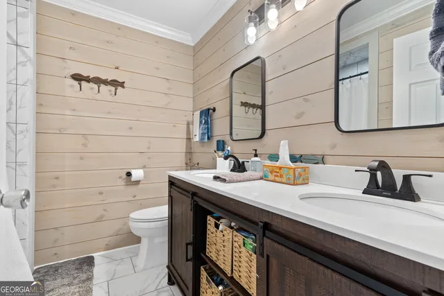 a view of a patio with lawn chairs floor to ceiling window and garden