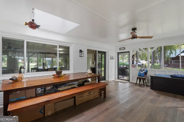 a view of a swimming pool with lawn chairs and wooden fence