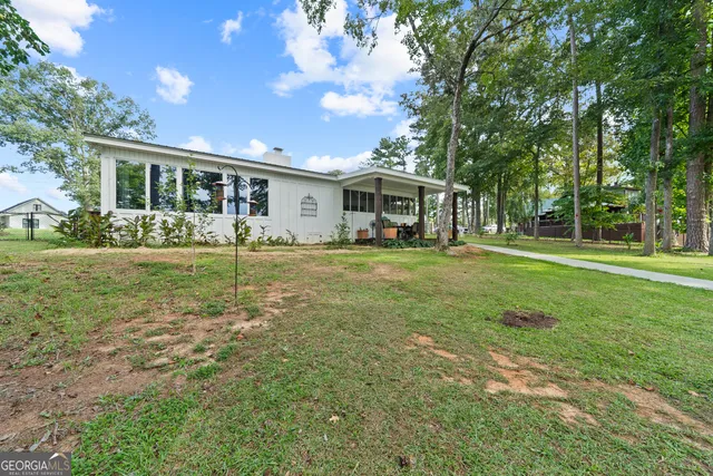 a front view of a house with yard patio and green space