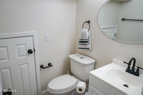 a bathroom with a sink a toilet and a mirror
