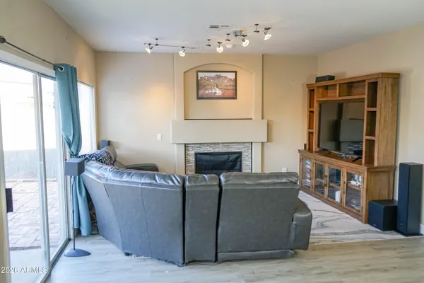 a living room with furniture a flat screen tv and a fireplace