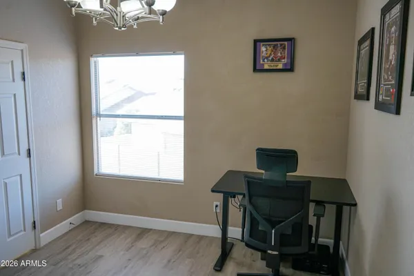 a view of a workspace with furniture and a window