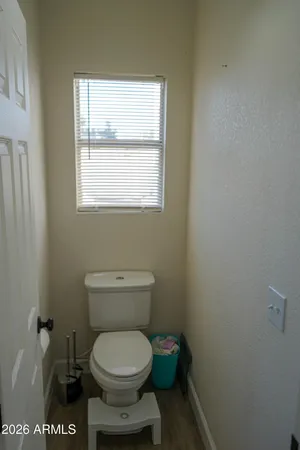a bathroom with a toilet and a window