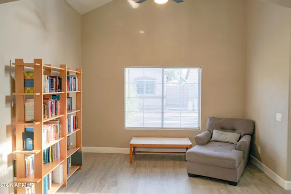 a living room with furniture and a window and a book shelf