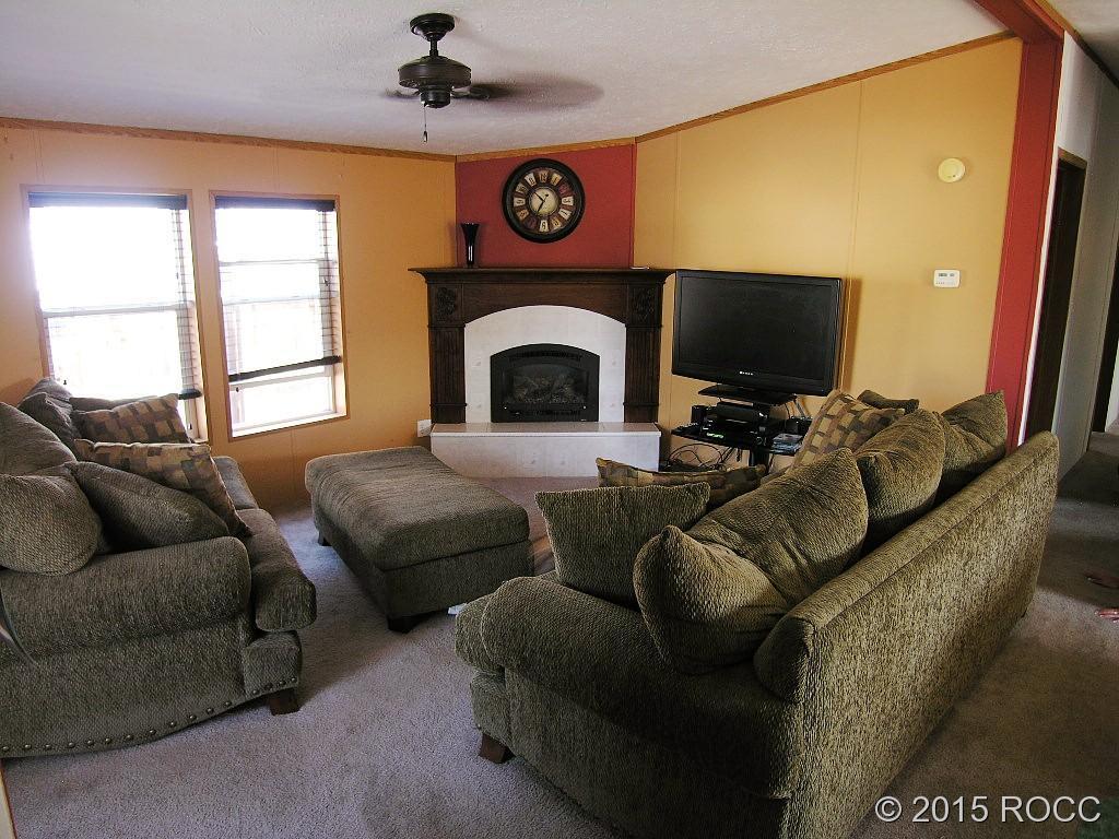625 Walnut Street Salida, CO 81201 - Photo 2 of 15 a living room with furniture a flat screen tv and a fireplace
