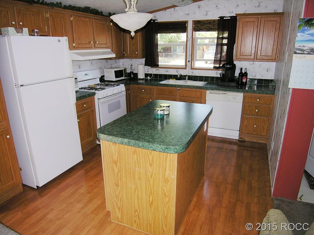 625 Walnut Street Salida, CO 81201 - Photo 5 of 15 a kitchen with granite countertop a refrigerator a stove top oven a sink and dishwasher