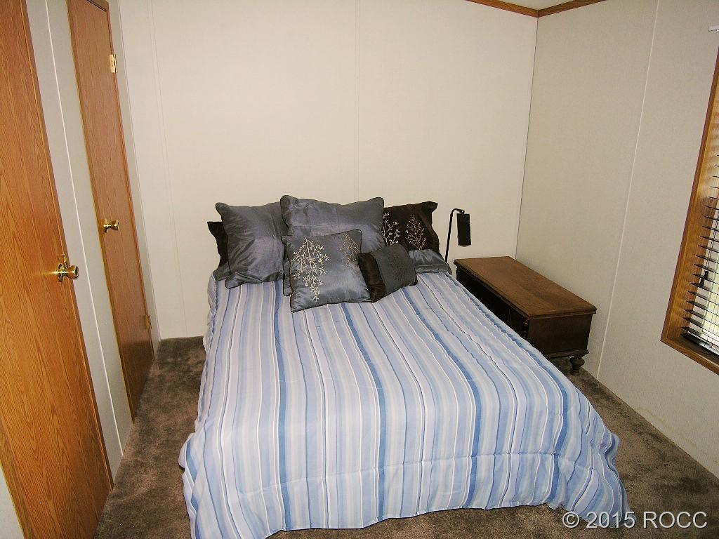 625 Walnut Street Salida, CO 81201 - Photo 9 of 15 a bed sitting in a bedroom next to a small yard