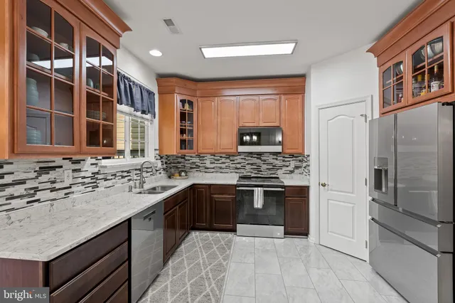 a kitchen with stainless steel appliances granite countertop a stove and a sink