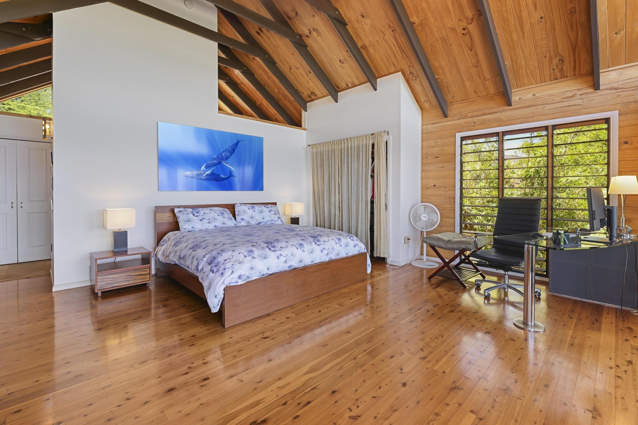 115 Ulua Road Kaunakakai, HI 96748 - Photo 17 of 49 a bedroom with a bed and wooden floor