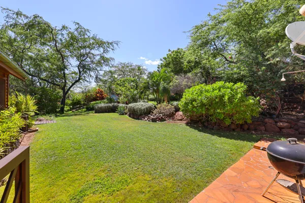 an aerial view of a house with a yard and lake view