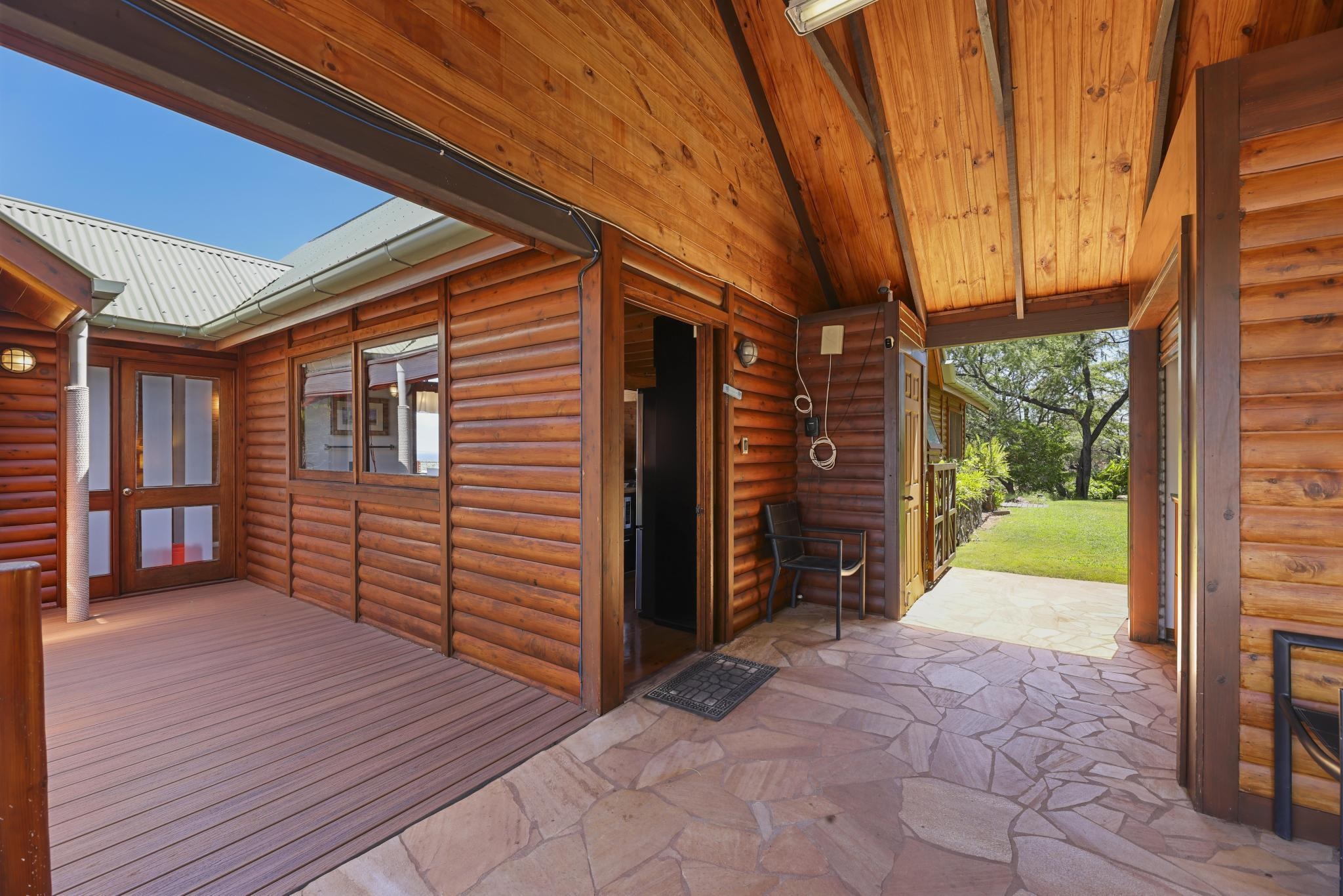 115 Ulua Road Kaunakakai, HI 96748 - Photo 39 of 49 a view of a porch with wooden floor and a yard