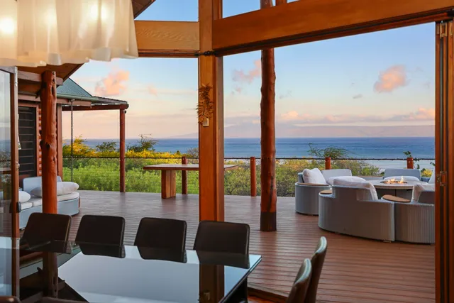 a view of a patio with couches table and chairs and potted plants