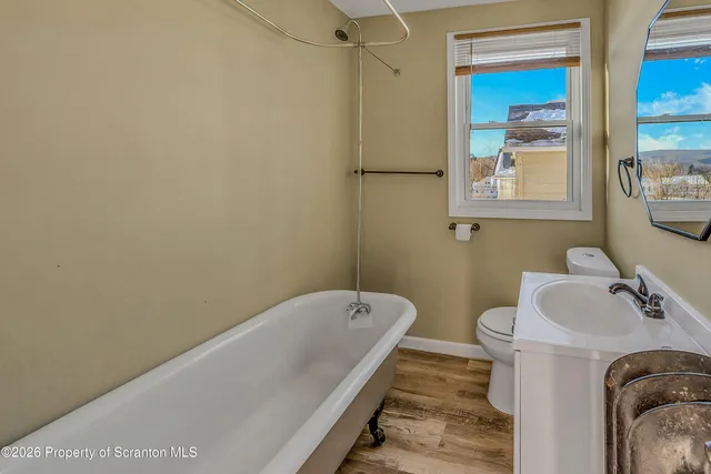a bathroom with a tub and sink