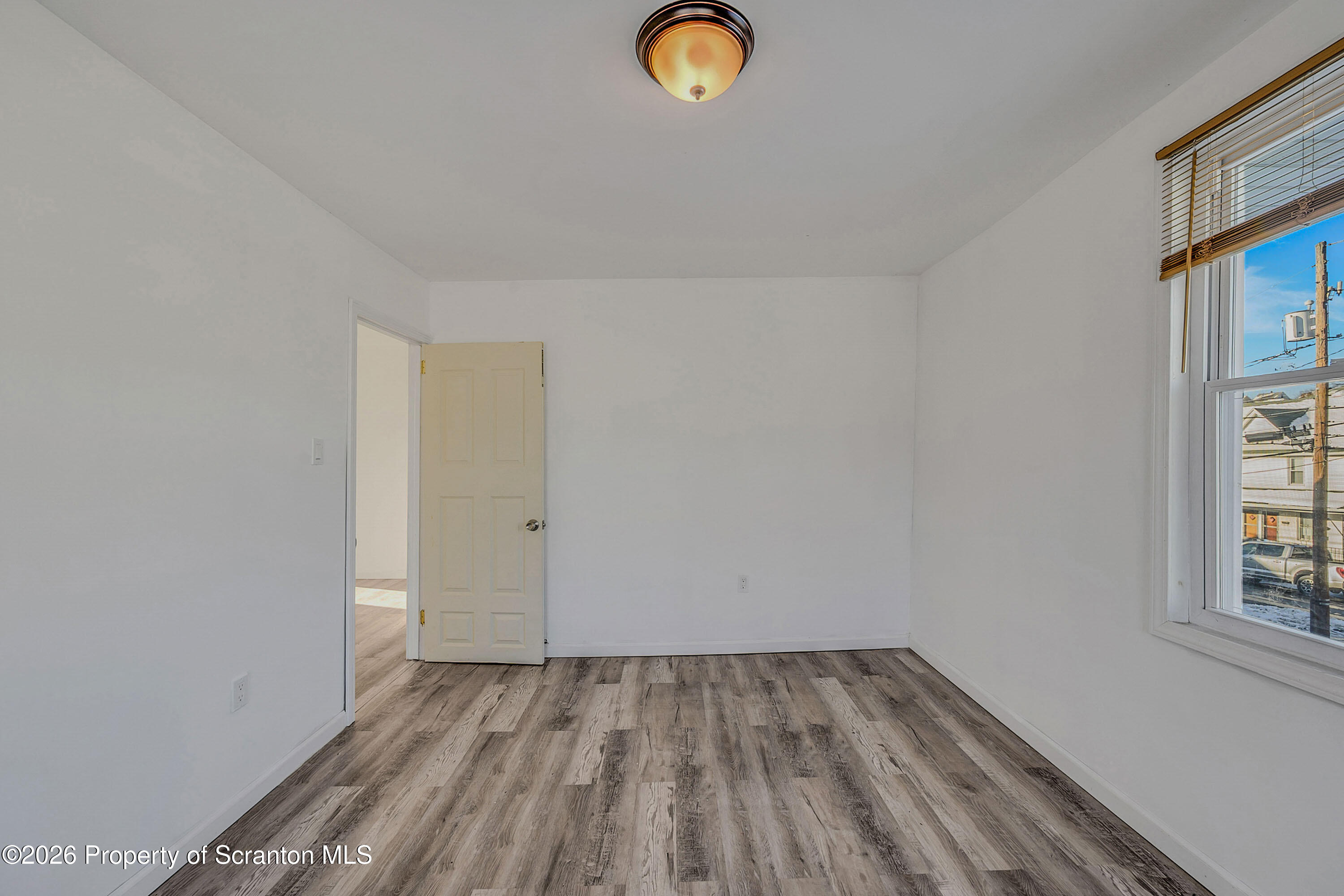 227 North Rebecca Avenue, Unit 2 Scranton, PA 18504 - Photo 8 of 18 a view of a room with wooden floor and window