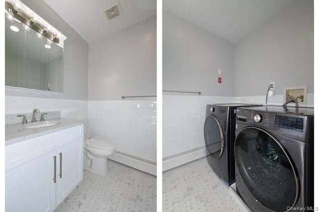 a view of a bathroom with washing machine and a sink