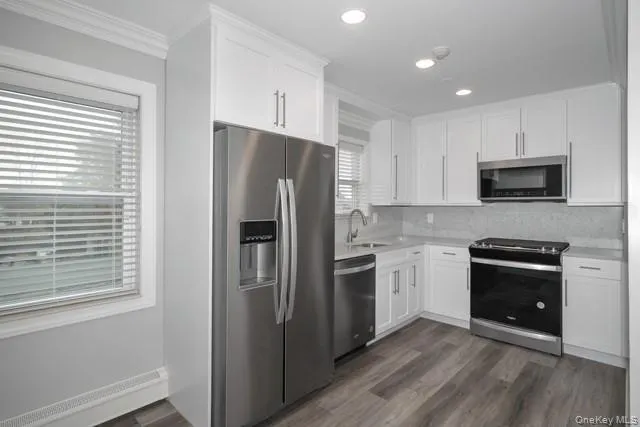 a kitchen with stainless steel appliances granite countertop a refrigerator stove and sink
