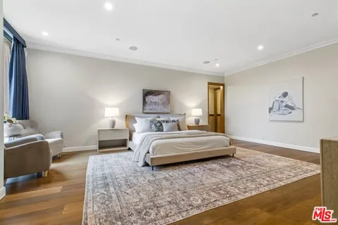 a spacious bedroom with a bed and a couch