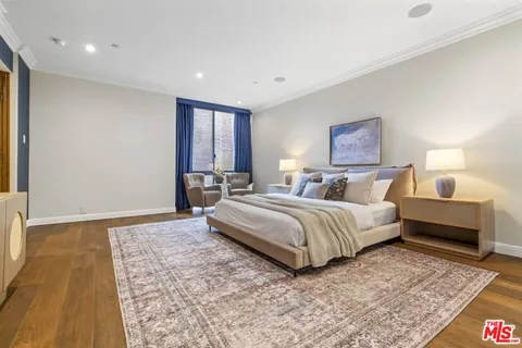 a spacious bedroom with a bed and a couch