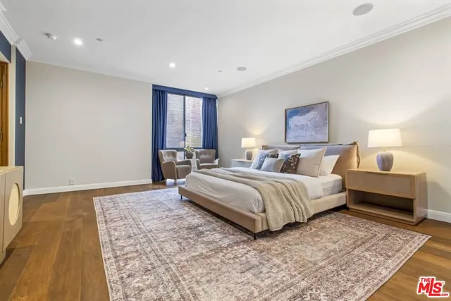 a spacious bedroom with a bed and a couch