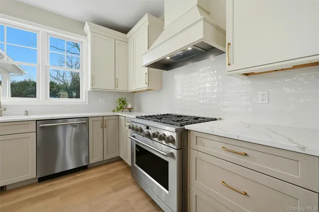 a view of a livingroom with a white wall and a window