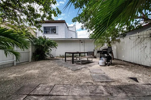 a view of a house with a yard and sitting area