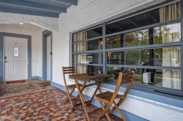 a view of a dining room with furniture and window