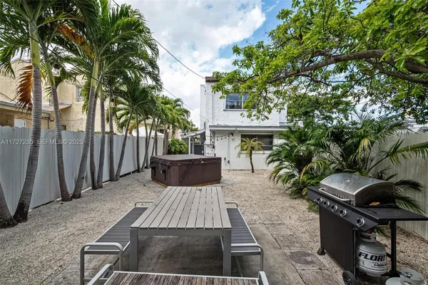 a view of a backyard with sitting area