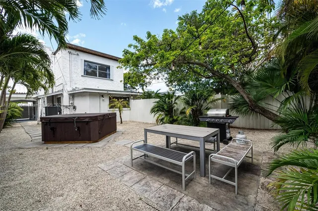 a swimming pool with outdoor seating and yard