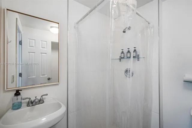 a bathroom with a sink and shower