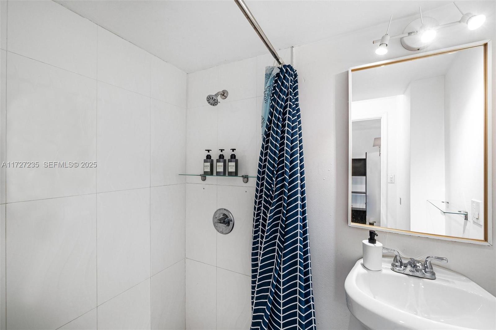 1428 Southwest 11th Terrace Miami, FL 33135 - Photo 19 of 36 a bathroom with a sink and a mirror
