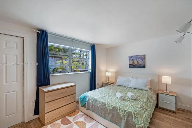 a bedroom with a large bed and a window